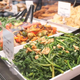 prepared foods deli trays at grocery store full of salads and entrees